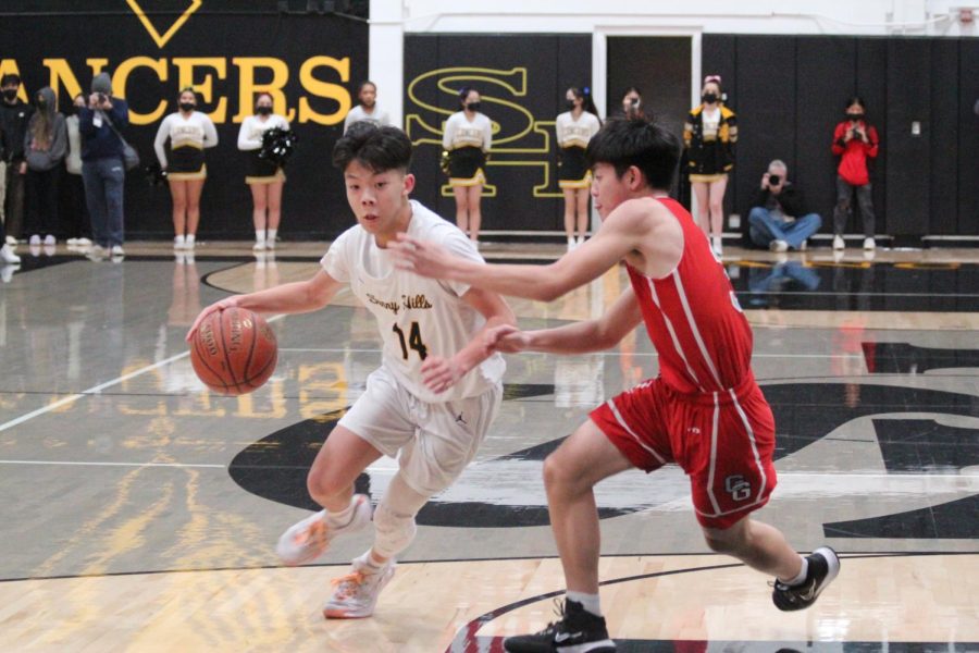 Junior point guard Chad Nguyen dribbles toward a Garden Grove player Feb 22. Even though the Lancers lost their semifinal CIF-Southern Section Division 4 game, the team won its first state CIF playoff game, since 2004, on March 1.