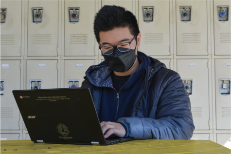  Senior Aidan Wong works on sharpening his Dutch skills through the Duolingo website on his Chromebook at the lunch tables near the 90s building on Feb. 23. 