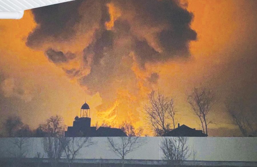 An oil depot explodes the morning of Feb. 27 — three days after Russian President Vladimir Putin launches a full-scale invasion on Ukraine — near the Kyiv region in the city of Vasylkiv. Military activity and explosions in the city have forced citizens to evacuate or find refuge in bomb shelters.