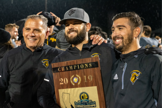 Peter Karavedas (center) holds the 2019 CIF-SS Division 8 Championship plaque after the Lancers defeated Santa Barbara High School 24-21 on Nov. 30, 2019.
