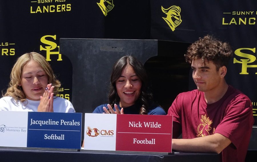 Seniors Jasmyn Morales (left) and Jackie Perales applaud for Nick Wilde on April 13 on National Signing Day during break in the quad. Wilde committed to the Claremont Mudd Scripps’s athletic program for football.