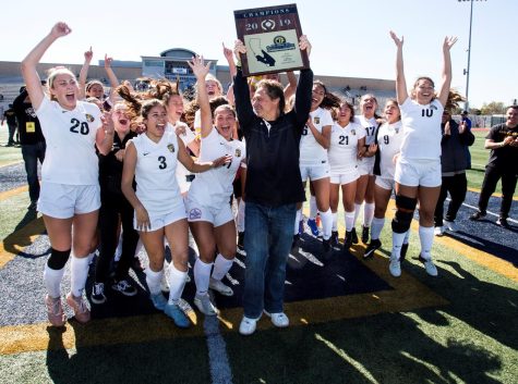  Girls soccer head coach Jeff Gordon (center) holds the CIF-SS Division 2 championship plaque in celebration with his team on Feb. 3, 2019, at Warren High School in Downey after defeating Mira Costa High School, 2-1. Gordon cultivated over 600 career wins, three CIF championship titles and 19 Freeway League titles. 
