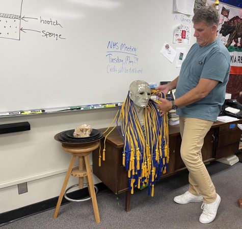 National Honor Society [NHS] adviser and English teacher Randy Oudega inspects the 61 NHS cords for seniors to wear on graduation day on Wednesday, May 18, in his classroom. The cords will be distributed on Tuesday, May 24, from his classroom during lunch, the same time when nearly 50 non-seniors will be inducted into the group.
