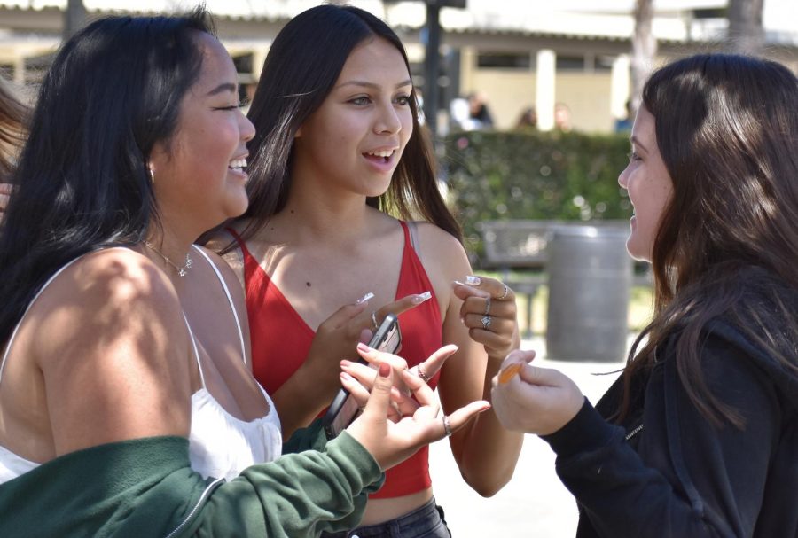 With the start of the new school year, seniors Rebecca Tualla (left), Camila Perez and Grace Hicks chat during lunch in the quad. 