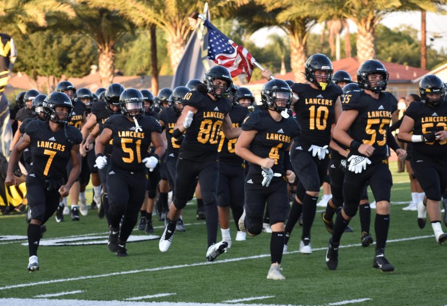 The+Sunny+Hills+Lancers+football+team+charges+onto+the+field+before+the+kickoff+of+its+first+game+of+the+2022-2023+season+Thursday%2C+Aug.+26%2C+against+Capistrano+Valley+High+School+at+Buena+Park+High+School+stadium.