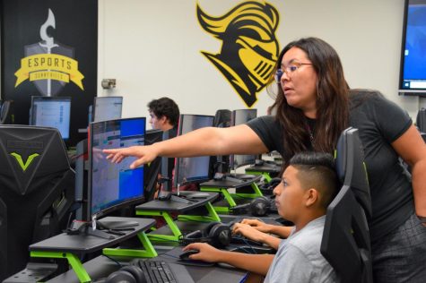 New computer science teacher Sonya Joyce instructs freshman Adrian Rodriguez about using the “println” statement to output the code correctly during her third period Coding and Gaming class in Room 44 Sept. 14.