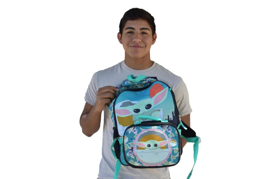 Senior Tony Salas holds his Grogu (Baby Yoda) backpack based on the Disney Plus series, The Mandalorian.