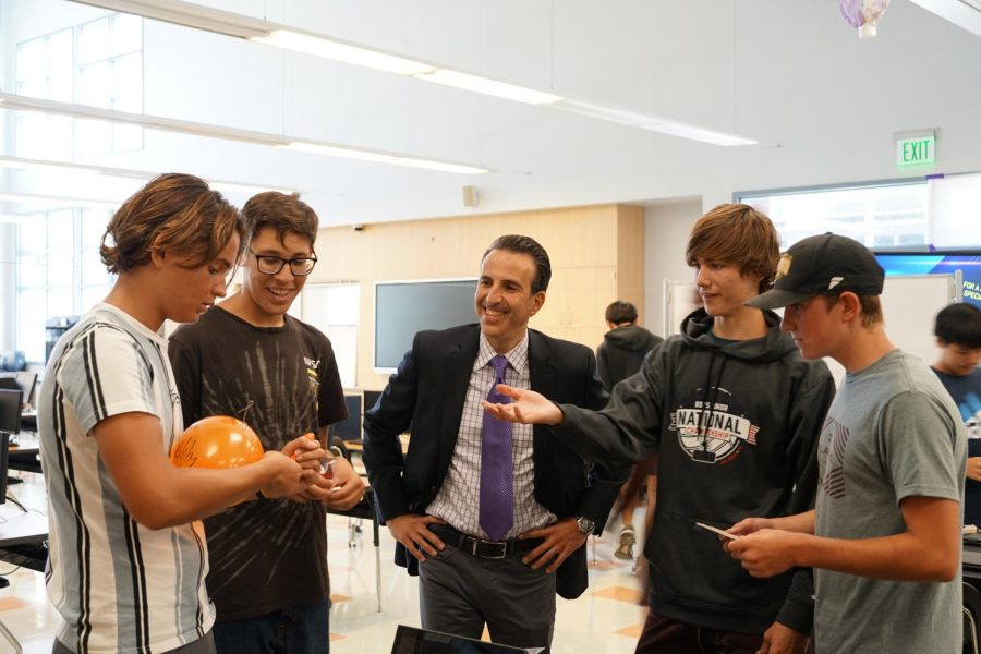 New engineering teacher Patrick Salem (center) reacts to the progress his engineering students are making on their balloon cable car project in Room 402 on Monday, Aug. 22.  Salem, hired through the Regional Occupation Program, also takes over as the new coordinator for the school’s Engineering Pathways to Innovations and Change program.