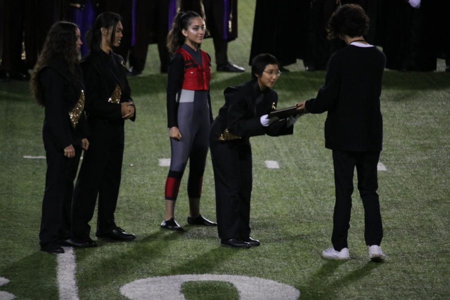 Drum major senior Lana Luu accepts a second-place plaque for the Lancer Regiment during the Saturday, Nov. 12, Division Championships at Capistrano Valley High School in Mission Viejo. The Lancer Regiment, comprised of the school marching band and the Color Guard, will advance to the championship round Saturday, Nov. 19, in Garden Grove, where they will compete for a chance to earn a first-place award for a second consecutive year.
