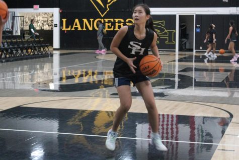 Power forward junior Silvia Lee prepares to shoot the ball in a drill during her Nov. 15 practice after school in the Sunny Hills gym. 