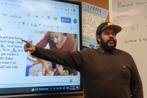 Sporting his Sunny Hills cap, Spanish teacher Luis Gomez reviews a warm-up exercise with his Period 4 Spanish 2 class last December in Room 56. 