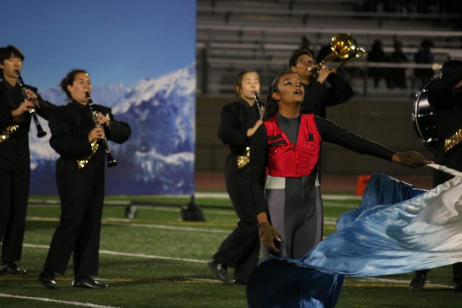 Color+Guard+member+sophomore+Janessa+Lima+%28center%29+swings+her+flag+while+other+members+of+the+Lancer+Regiment+behind+her+play+their+instruments+during+%E2%80%9CThe+Summit%E2%80%9D+performance+Saturday%2C+Nov.+19%2C+at+Bolsa+Grande+High+School.