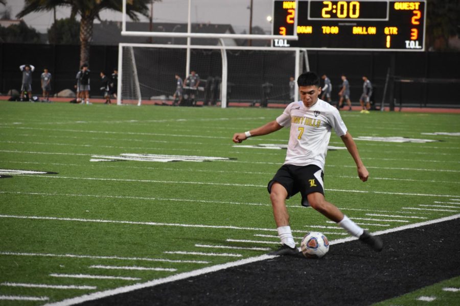 Forward+junior+Issac+Morales+prepares+to+pass+the+ball+on+Wednesday%2C+Jan.+11%2C+during+an+away+game+against+Buena+Park+High+School+at+Buena+Park+High+School+stadium.