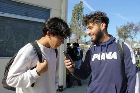 Junior Abanoub Bishay (right) asks for sophomore Luke Corrales’ help in the quad during lunch on Wednesday, Jan. 18 to demonstrate how he interviews students for Bishay’s Quote of the Day series on his Instagram Reels.