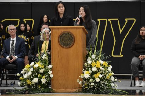 Seniors Alejandra Quismorio (left) and Kate Yang team up to deliver a speech about their experience as International Baccalaureate students in the gym as part of the opening ceremonies of the Jan. 24 Open House for eighth-graders and their parents. The pair was among six student speakers selected by school officials to tout the variety of programs offered at Sunny Hills.
