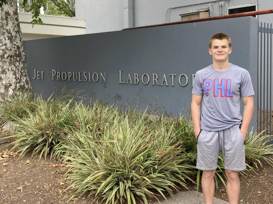 Senior Thaddaeus Kiker stands in front of the Jet Propulsion Laboratory in Pasadena early June 2022 before he starts his internship, which he completed virtually because of the COVID-19 pandemic. However, he visited the center to get “badged” — the process of issuing the identification card for NASA to ensure security.