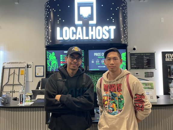 Chemistry teacher Alexander Hua (right) stands next to his opponent, Kevin Granados, whom he beat in the final match of Fullerton's gaming arena Ultimate Weekly #50 competition on Sunday, Jan. 8.