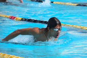 Senior Julian Boyd practices his butterfly stroke for the upcoming season after school in the Sunny Hills pool Monday, March 13.