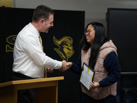 Principal Craig Weinreich (left) shakes the hand of junior Karen Huang, who received an Exceptional Effort and Engagement award, also known as E cubed, on Wednesday, March 1, in the Lyceum. Engineering teacher Patrick Salem nominated Huang for the recognition sponsored by the Parent Teacher Student Association [PTSA], which for the first time held a meeting on campus in the evening to honor the second group of E cubed recipients this school year. 