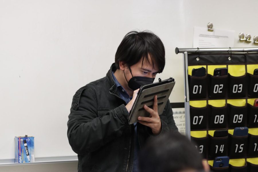 Rico, partially blind since he was 10, uses an iPad to upload academic material for the students.