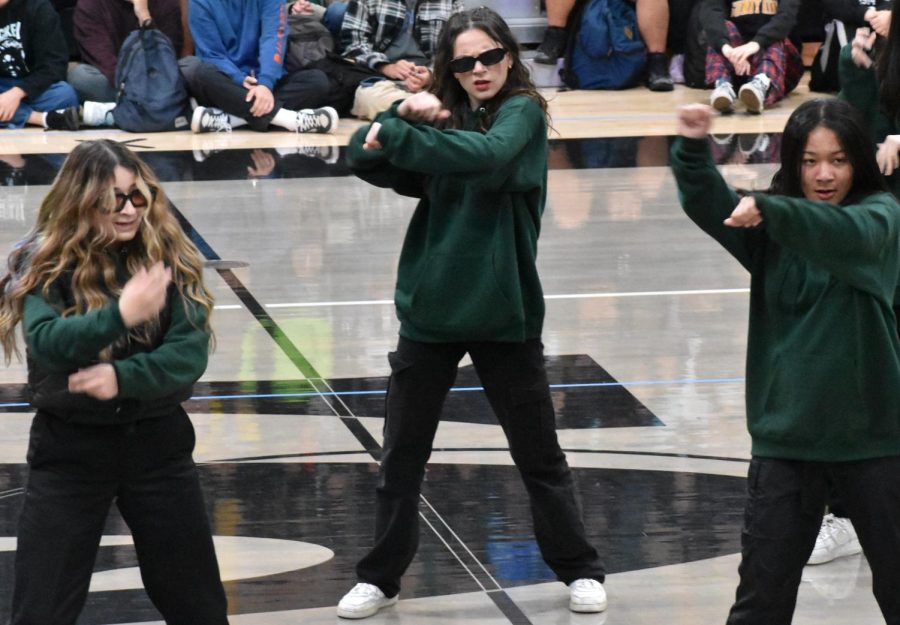 Deviation member senior Monique Alvarado (left) dances alongside senior Dorotea Barbini and sophomore Madelyn Boyd to “Family Ties” by Baby Keem on March 10 at the spring assembly.