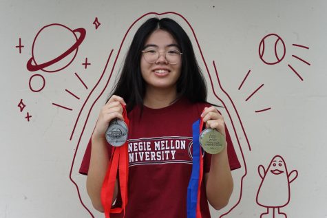 Senior Veronica Diaz holds up the first and second-place medals she earned from the world championships with the FIRST Robotics Competition team for the past two years. (Illustrations by DaHee Kim)