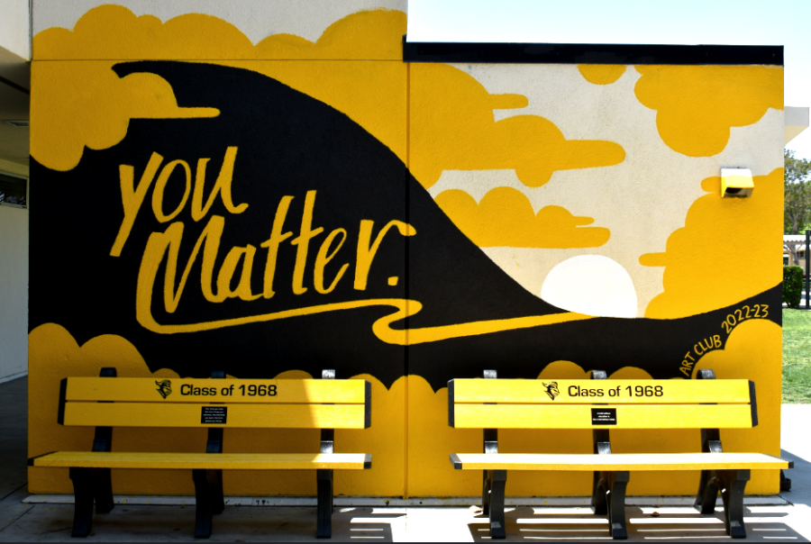 The mural completed Monday, May 1, features a black hill with the words “You Matter” on it, surrounded by yellow clouds and a sun setting near the foot.
