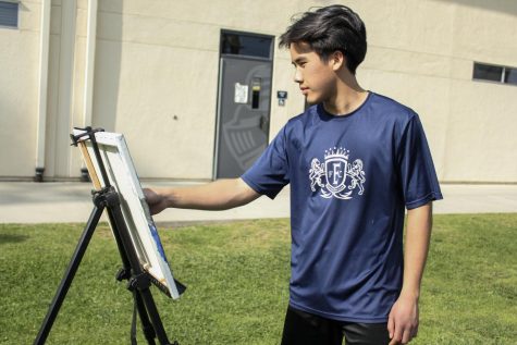 Senior Jake Merioles paints an image of a
tree by the the Lyceum April 18. The painting is a continuation of his outdoor art ventures.