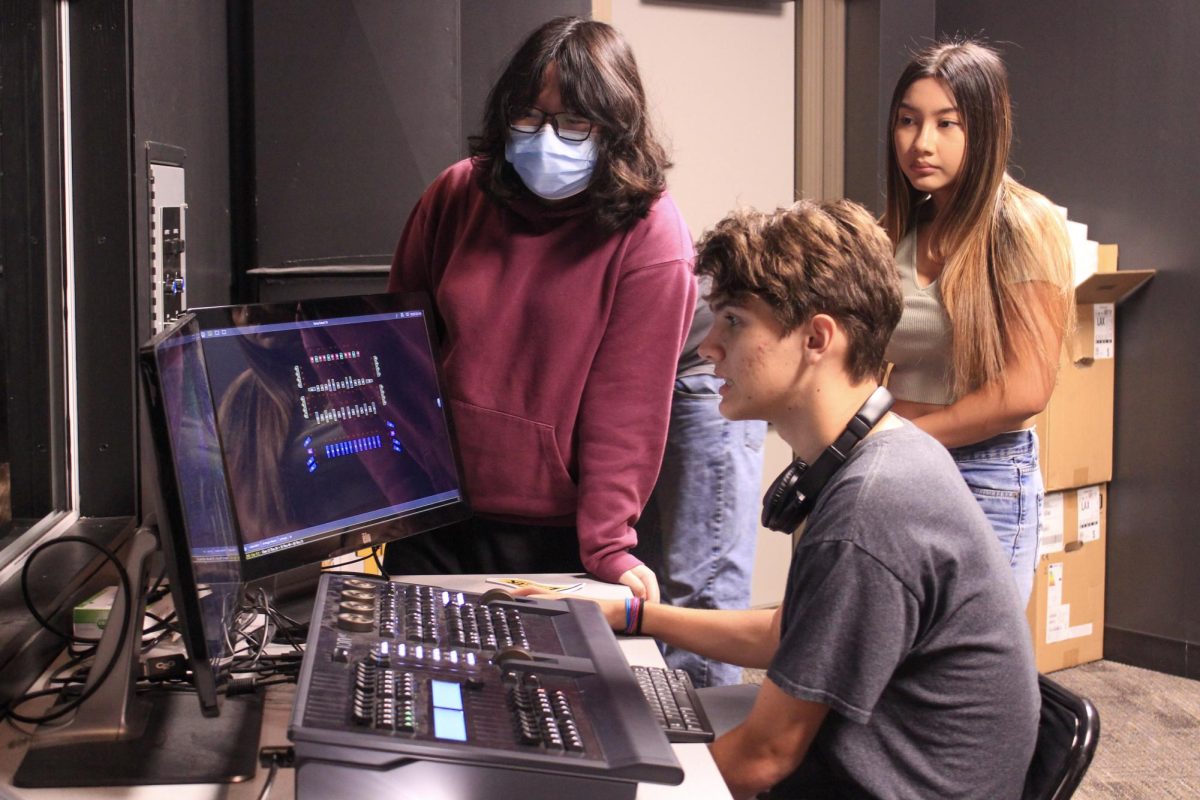 Senior Rachel Kim (left) oversees sophomore Draven Dovalina working on the lighting equipment in the Performing Arts Center during their second period Technical Theater class on Wednesday, Aug. 30.