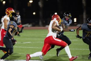  Safety senior Elleion Lemon gets ready to tackle the Woodbridge High School player on Thursday, Aug. 31, at Buena Park High School Stadium. The Lancers’ defense held the Warriors to 13 points, as their offense under first-year quarterback sophomore, Madden Leasau, helped Sunny Hills secure the victory with 21 points.

