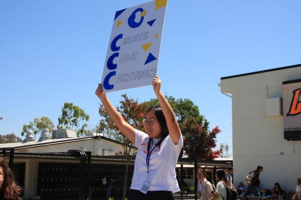 Junior Celine Huh promotes Create Code Construct in the quad with a hand-made poster on the first day of Club Rush, Tuesday, Aug. 29.