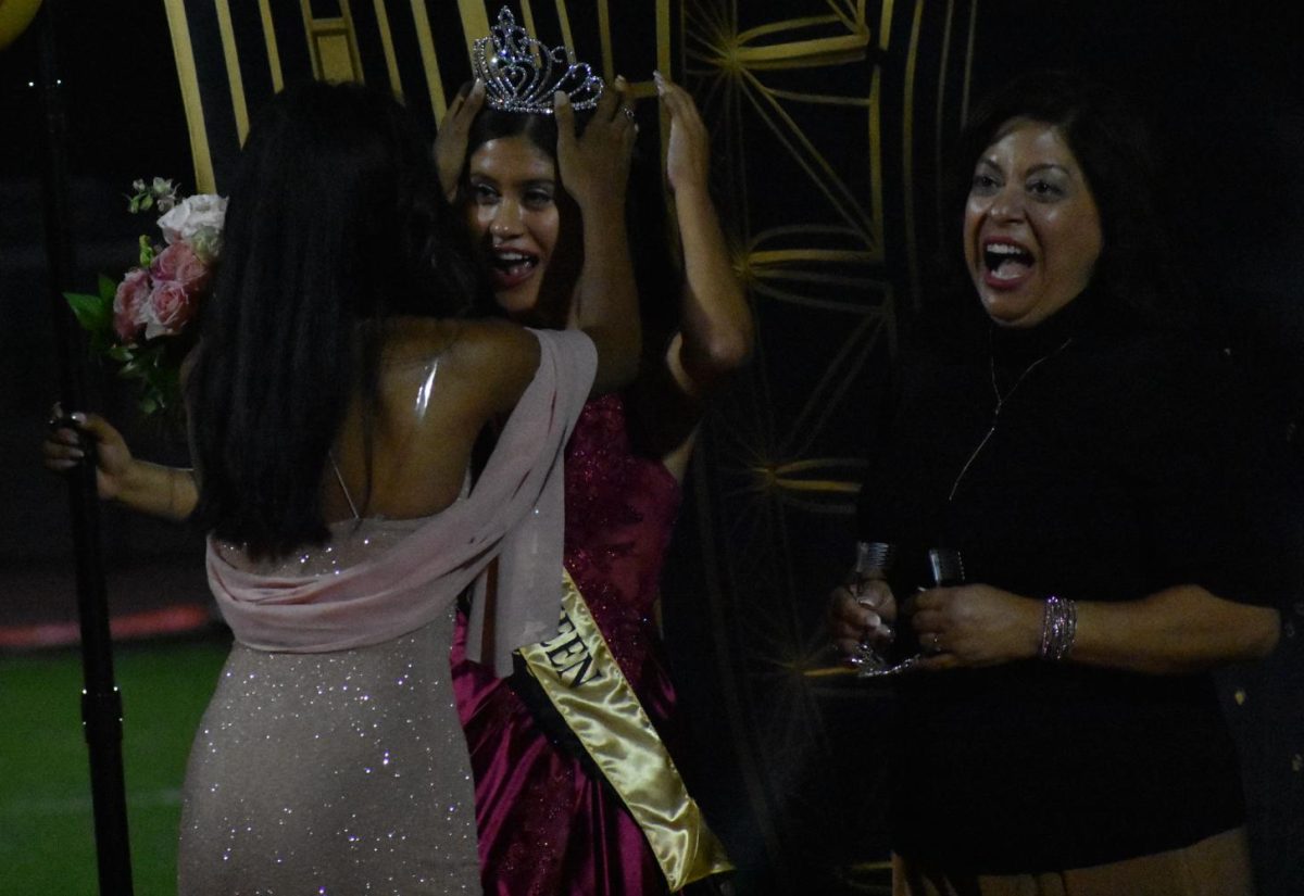 Senior Katie Ortega (left) and her mother react to the announcement naming Ortega as the 2023-2024 homecoming queen. The coronation was held during halftime of the Friday, Sept. 29, football game between Sunny Hills and Sonora at Buena Park High School stadium.