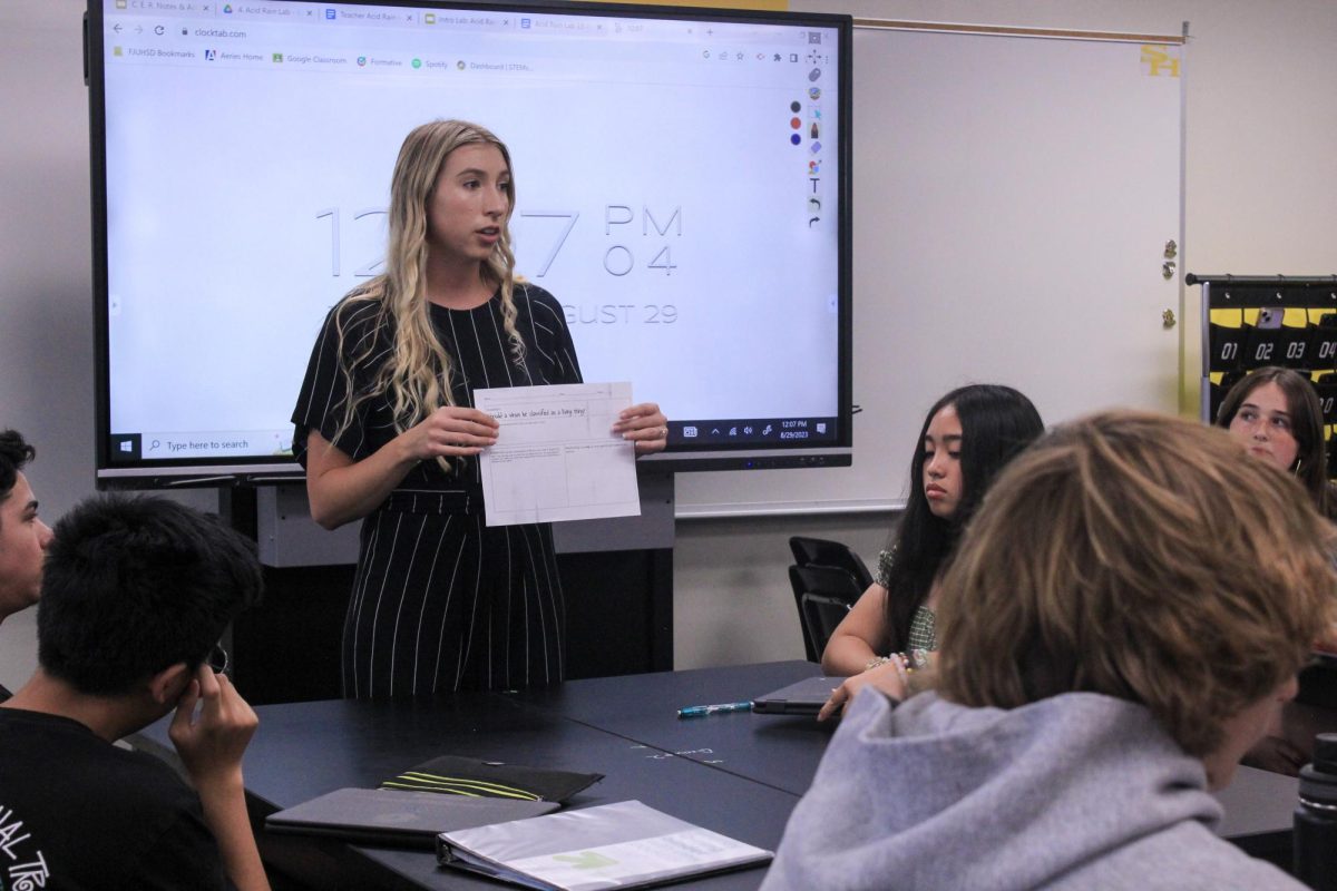Biology teacher Monet Favreau explains how to complete a worksheet about living organisms to her fourth period class on Aug. 29.