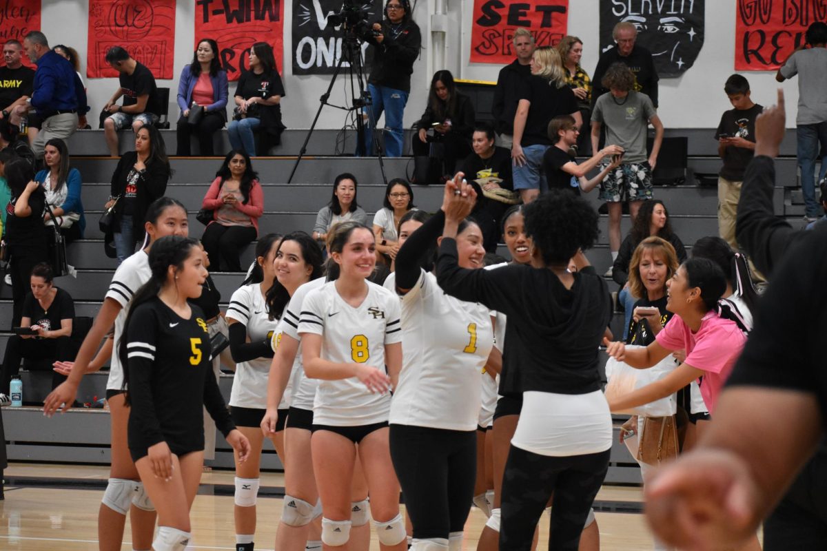 Setter junior Dalilah Rivero gives a high-five after the girls volleyball team’s dominant win over Troy High School in straight sets 25-16, 25-15, 25-18 at an away match on Wednesday, Oct. 11. The team claimed the Freeway League champions title for the first time since 1995.
