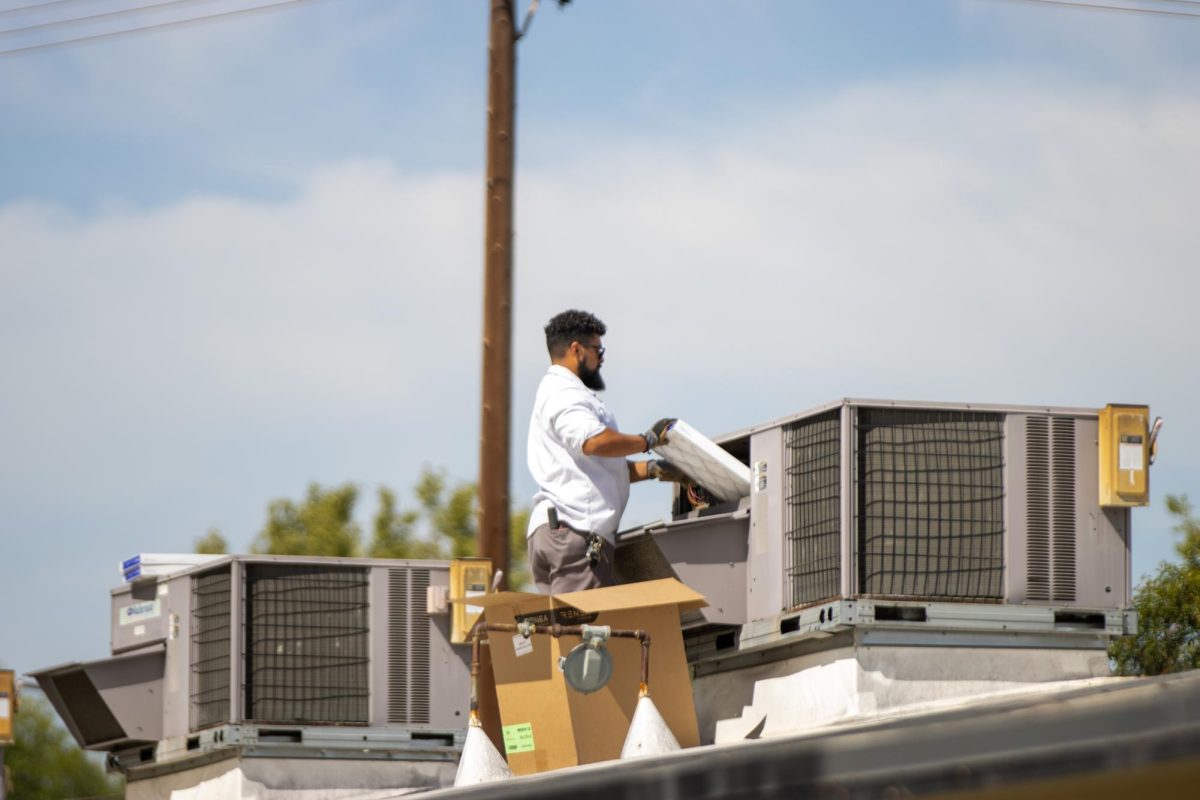 A repairman replaces the filter for the air conditioning unit on the rooftop of the 110s wing on Wednesday, Sept. 27.