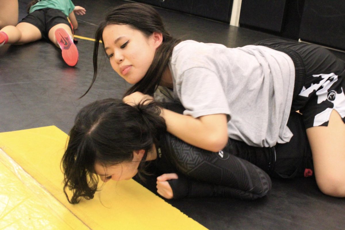 Senior SooRin Hwangbo (top) and sophomore Keira Suh practice their techniques in the Sunny Hills wrestling room Wednesday, November 15, to train for their first Freeway League match at home against the Sonora Raiders on Wednesday, Nov. 29. 