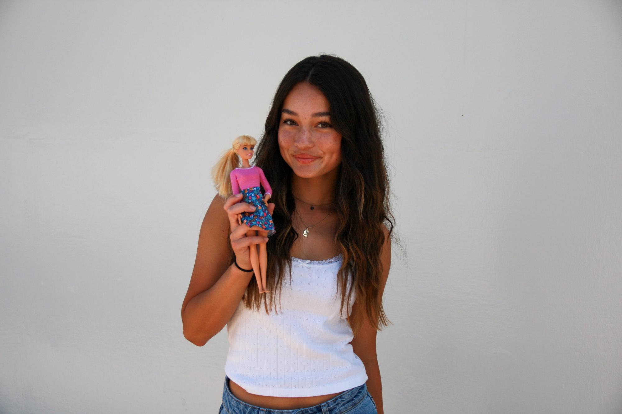 Junior Sloane O’Connor holds a Barbie doll in her hand while bringing her back into her younger days of playing with the doll.