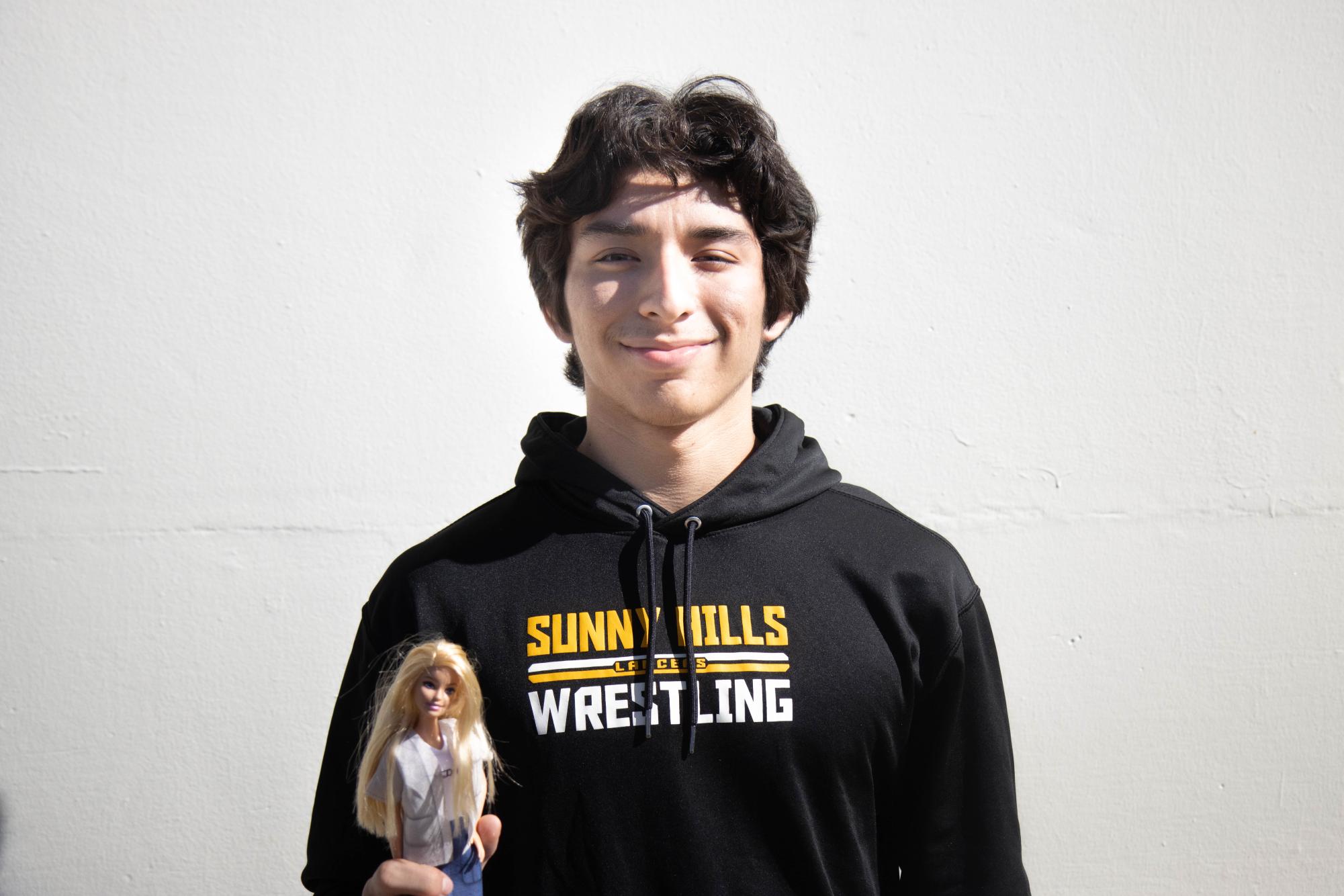 Senior Michael Amescua holds the Barbie doll he bought after watching the movie.