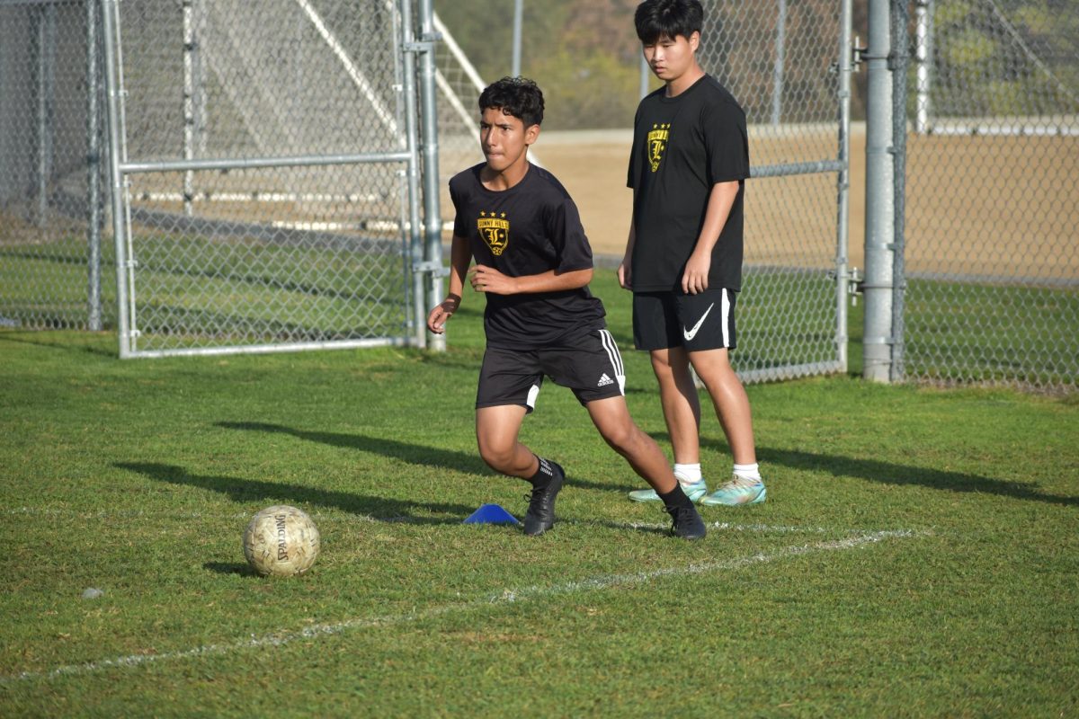 Freshman Alexis Arroyo Garcia, who plays midfielder, dribbles a soccer ball across the Sunny Hills field during sixth period on Thursday, Nov. 30. The team’s non-league record is 4-1-1, with its only loss to Canyon High School in Anaheim, and the first Freeway League game will begin Tuesday, Dec. 12.