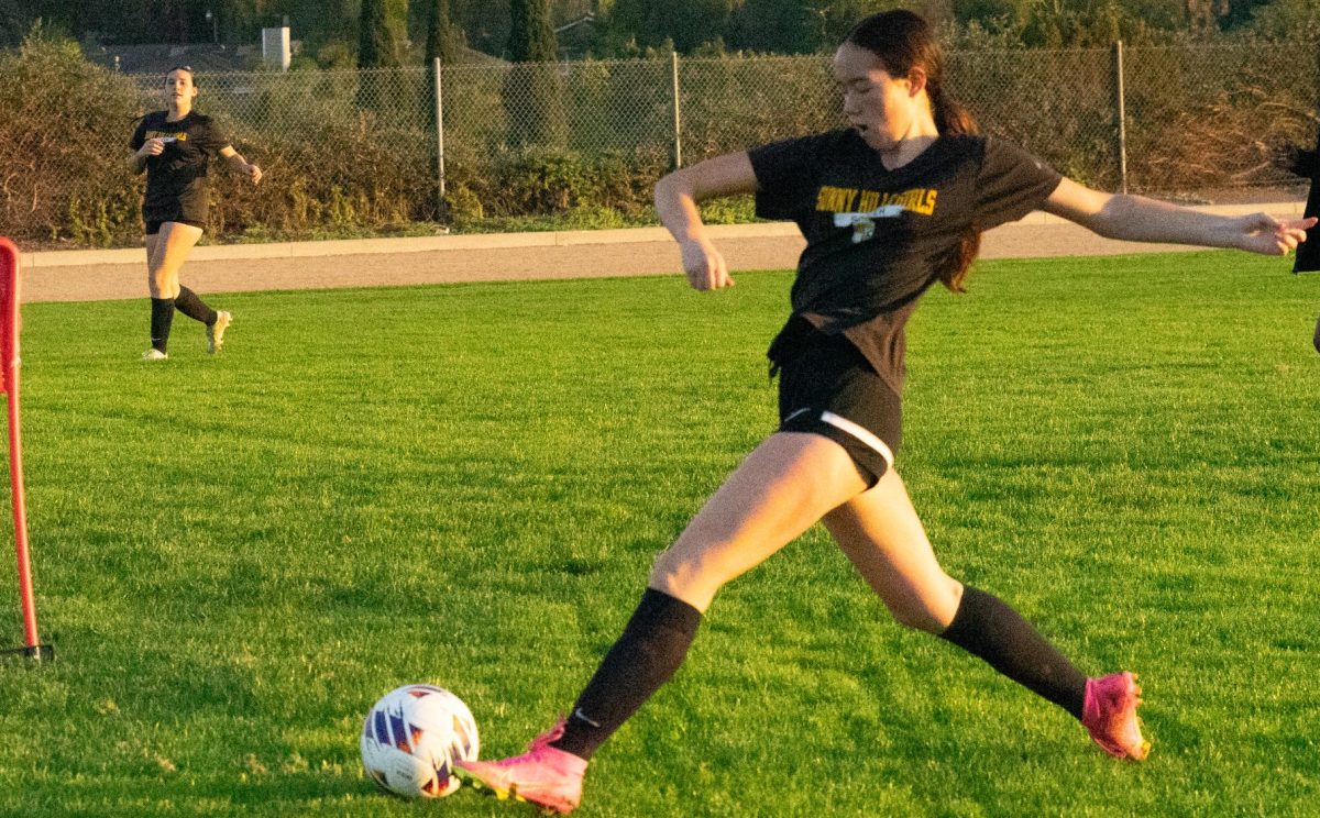 Sophomore Elly Sweeney reaches for the soccer ball at the Sunny Hills field during an after school practice on Monday, Dec. 4. The Lady Lancers will kick off their Freeway League season at an away game against Sonora High School.