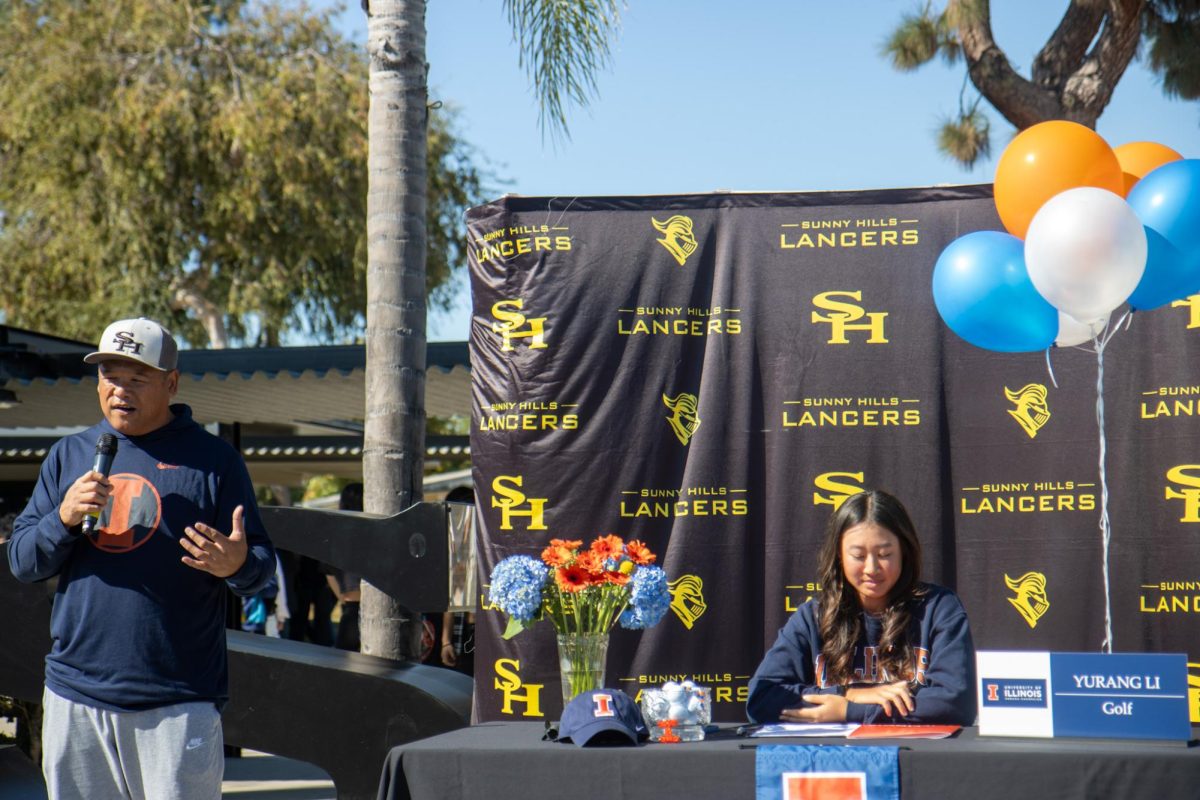 Girls golf head coach Scott Enrico says a few words about senior Yurang Li during her signing to the University of Illinois at the SHHS quad on Wednesday, Nov. 8.