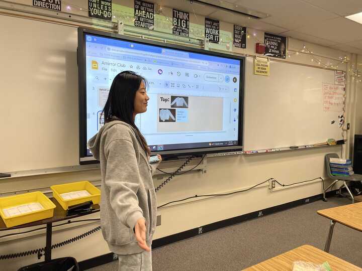 AMirror club co-president sophomore Stacy Kim presents a Google Slides presentation about plans to sell clothes during the clubs lunch meeting in Room 92 on Wednesday, Jan. 10.