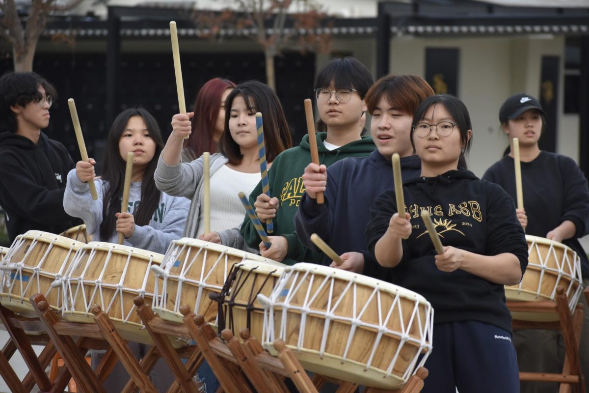 Korean Culture Club [KCC] members play the nanta, a traditional Korean drum, for their International Food Fair [IFF] audition performance after school in the quad on Wednesday, Jan. 17. Culture clubs will showcase their performance during the IFF assembly on Friday, Feb. 16.