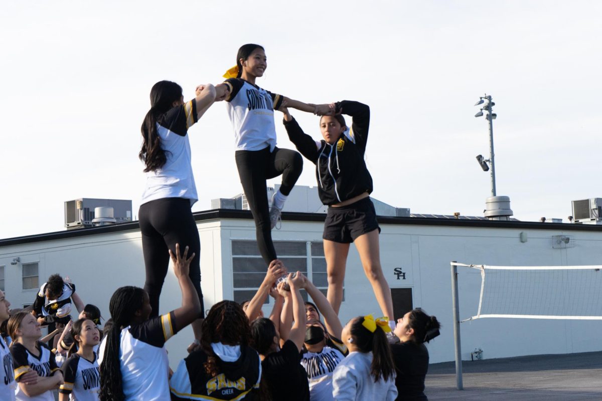 Sophomore Charlise Tolentino (center) lifts her left leg up as part of the pyramid that her teammates are working on during the Lady Lancers’ period six practice behind the Sunny Hills PE locker rooms on Tuesday, Jan. 9. The team will compete in its first competition on Saturday, Jan. 13, at Agoura High School. 