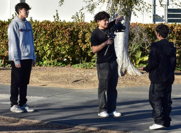 Junior Jose Antonio Ferrero (left) from sixth period video production supervises a shoot outside the 130 building on Thursday, Jan. 11, between senior Favian Henriquez, whos getting his equipment ready, and freshman Carlos Valdez.