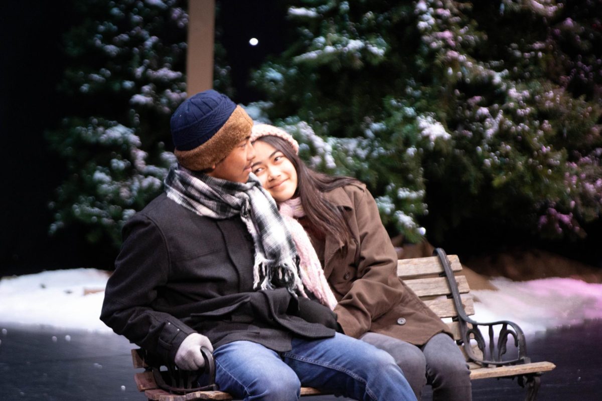 Senior Logan Villanueva (left) sits with sophomore Katie Fahl on a bench during the dress rehearsal of “Almost, Maine” on Wednesday, Feb. 7, at the Performing Arts Center.