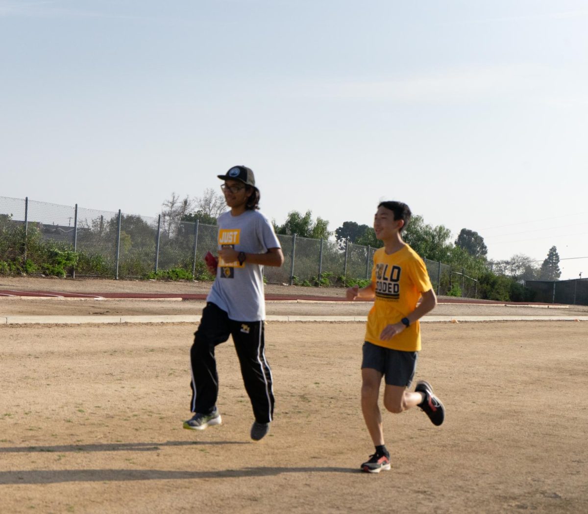 Junior Alex Rivera (left) and sophomore Ronin Nguyen practice for distance running Friday, Feb. 16, after school on the Sunny Hills track.