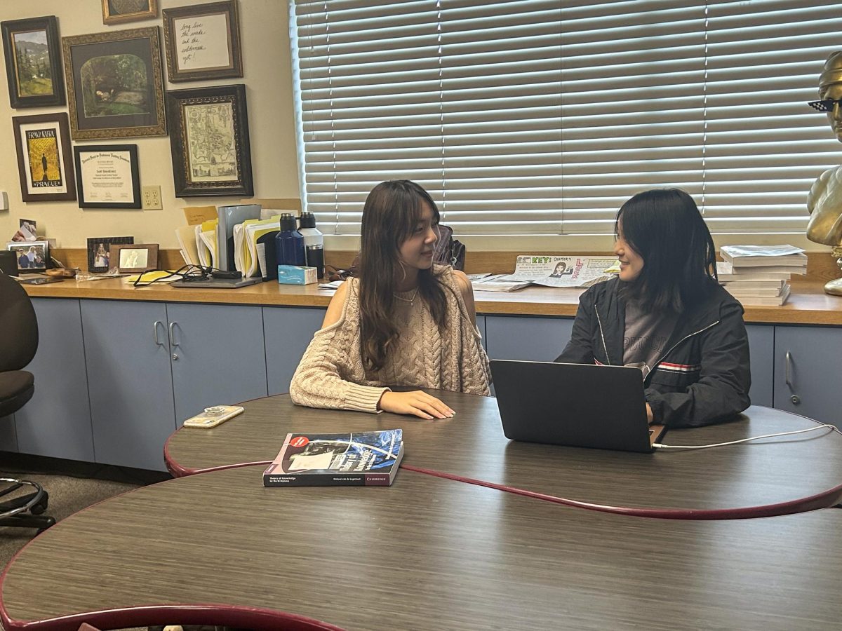 Writing Lab tutor senior Jennifer Yoon (right) chats with fellow tutor junior Kailyn Lee while waiting for students to arrive to Room 180 on Thursday, Oct. 26.
