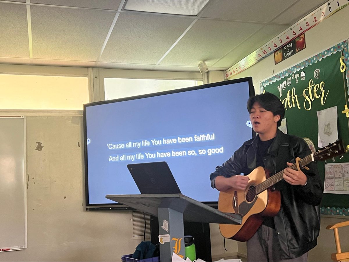 With a guitar in hand, junior Hochang Lee leads his new club, The Blessing, in worship songs to God on Wednesday, March 13, in Room 97. Even though the songs are in English, Lee – the club’s founder and president – hopes to differentiate The Blessing from the Hallelujah Club in providing a place where Korean-speakers would feel more comfortable.