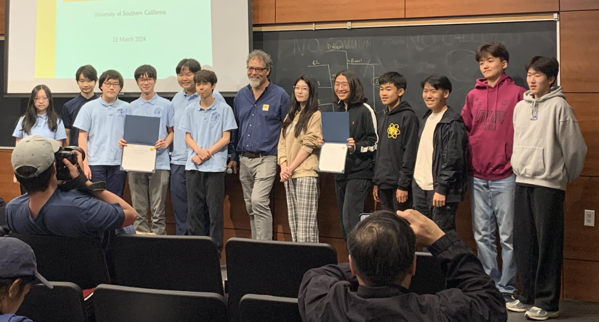 The six-member Sunny Hills Math Club team (right) joins those from Sierra Canyon School to recognize their first-place tie in the Southern California Mathematics Competition Division B contest with assistant professor of mathematics Nathaniel Emerson at USC’s Taper Hall Saturday, March 23. 
